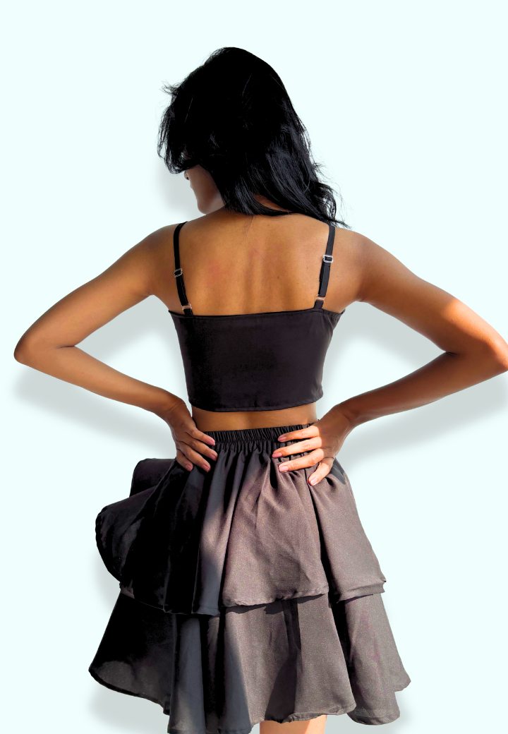 This image features the back view of a woman modeling the "Celestial Deepheart Black Dress". The dress has a fitted bodice with spaghetti straps and a plunging back neckline.
