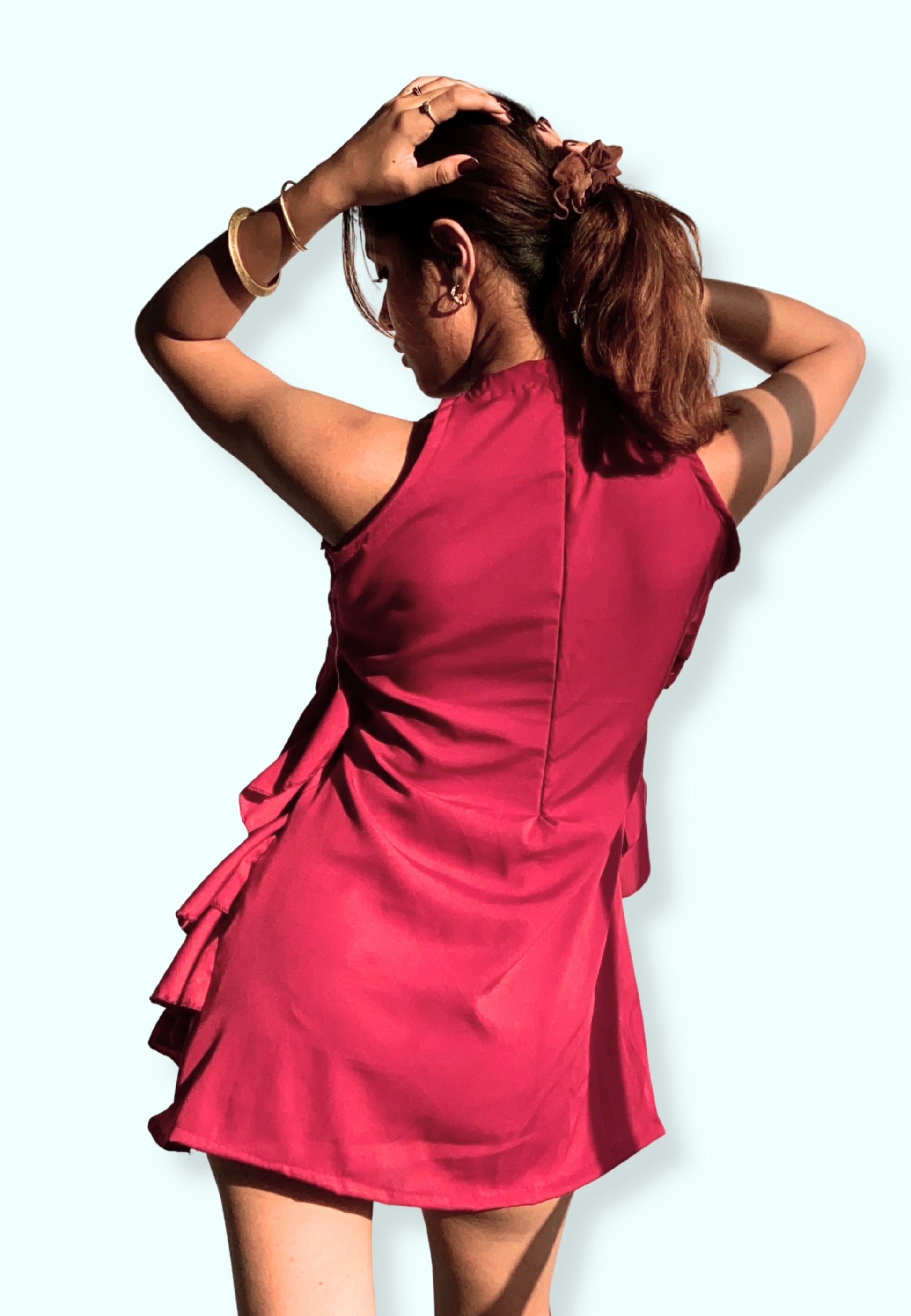 Woman wearing a red dress with a plain background