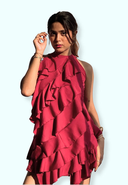 Woman wearing a red ruffled dress against a white background