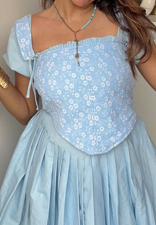 Light blue floral dress with a plain background